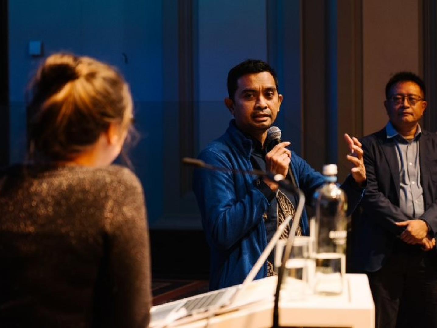Person speaking into microphone