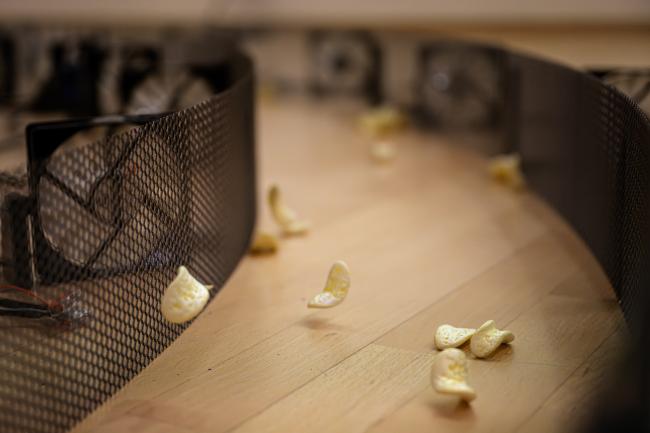 Art installation by Martin Lucas Schulze where little styrofoam chips are brought into movement by small fans.